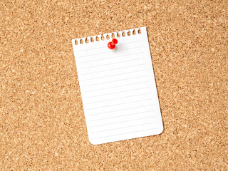 A note paper on a corkboard with red pushpin