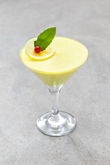 Lemon cream jelly, Panna Cotta in a martini glass. Dark background	