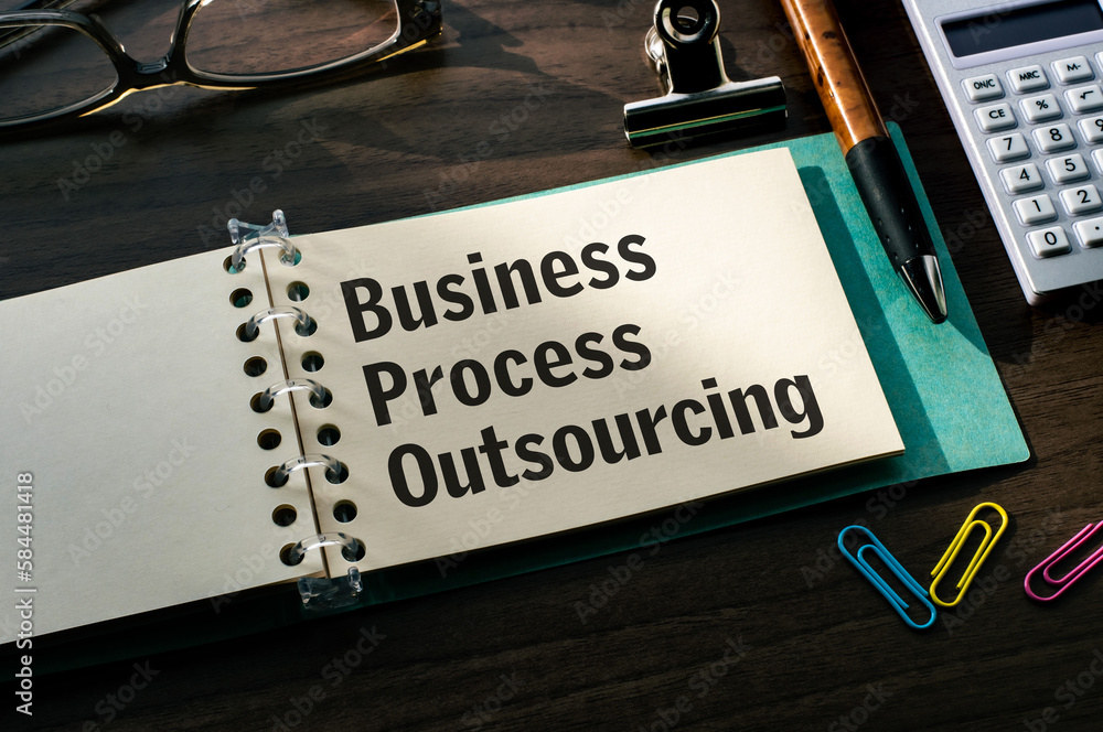 Poster there is a notebook with the word business process outsourcing. it is eye-catching image.