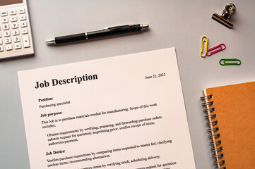 There is dummy documents that created for the photo shoot on the desk about Job Description.