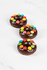 Easter dessert. Chocolate donut with chocolate glaze and decorated with colored candy dragees....