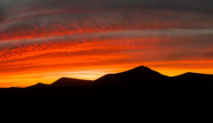 Beautiful and dramatic sunset colours over the volcanic mountain range near Corralejo in Fuerteventura Canary Islands Spain