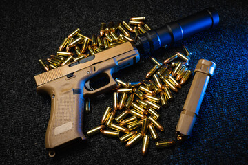 A sand-coloured pistol with a silencer and 9mm cartridges.