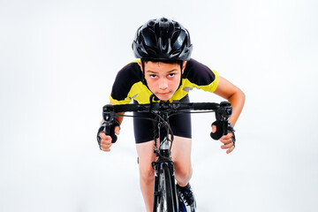 Young preteen cyclist riding bike in biking uniform in studio with white background