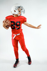 Youth preteen boy football player in uniform studio