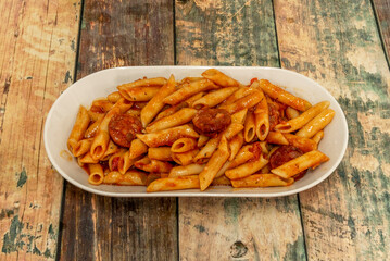 Macaroni with chorizo is a dish of Spanish cuisine that uses pasta and pieces of chorizo in tomato sauce in its preparation. Its appearance dates from the postwar period of the civil war.