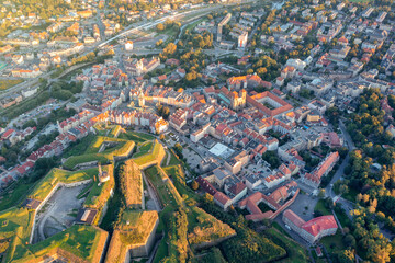 Panorama of the old town of Klodzko from above, beautiful cityscape at sunset and red tiled roofs