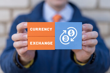 Businessman holding colorful blocks with inscription: CURRENCY EXCHANGE. Global currency exchange transfer concept. Lending foreign currency. Cryptocurrency exchange.