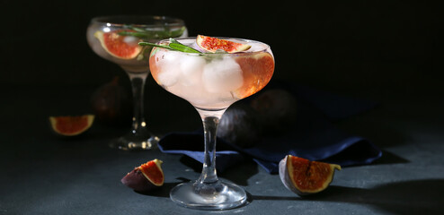 Glasses of fresh fig lemonade on dark background