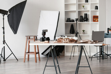 Interior of photo studio with table and professional equipment