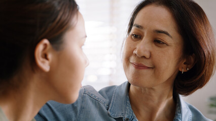 Middle aged asia people old mom love care trust comfort help young teen talk crying stress relief at home. Mum as friend listen adult child woman feel pain sad worry of broken heart life crisis issues
