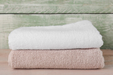 Folded soft towels on wooden table