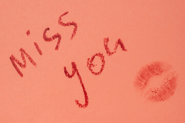 Miss you - red lipstick lettering on pink