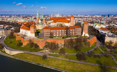Fototapeta na wymiar View from drone of medieval Сastle complex on Wawel Hill on background of Krakow cityscape in spring day, Poland