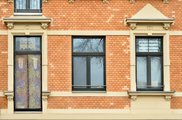 View of brick building with wooden windows