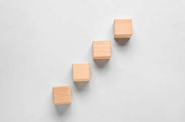 Wooden cubes with check marks on grey background