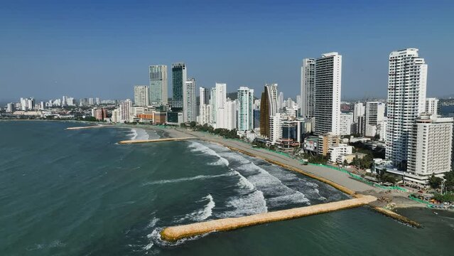 Drone shot rising in front of Bocagrande beach and skyline, sunny day in Cartagena, Colombia