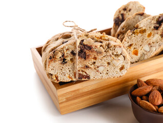 Box with delicious biscotti cookies, nuts and dried apricots isolated on white background