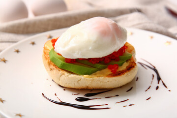 Plate with tasty egg Benedict on white table, closeup