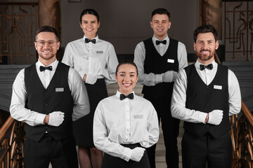 Group of trainees wearing formal clothes in hotel. Professional butler courses