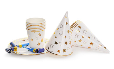 Party hats with caps, plates and whistles on white background