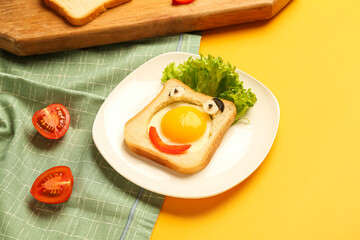 Plate with funny toast and tomatoes on yellow background, closeup