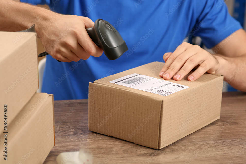 Sticker Post office worker with scanner reading parcel barcode at counter, closeup