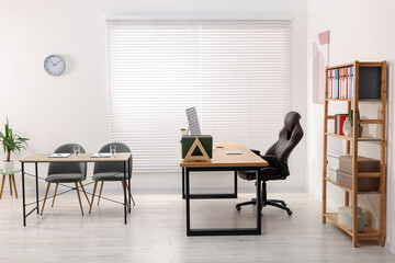 Director's office with large wooden table and comfortable armchairs. Interior design