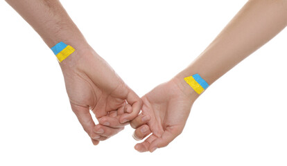 Man and woman with painted Ukrainian flags on their hands against white background, closeup
