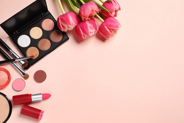 Obraz na płótnie Canvas Flat lay composition with different makeup products and beautiful tulips on beige background, space for text