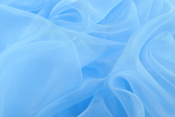 Beautiful light blue tulle fabric as background, closeup