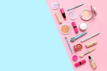 Decorative cosmetics with makeup brushes on blue and pink background