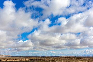 Fototapeta na wymiar Monsoon clouds over a low arid plain in the American West.
