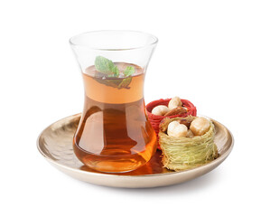 Glass cup of tea with Turkish delight on white background