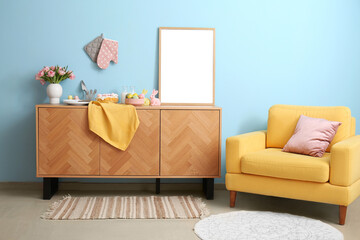 Interior of stylish room with Easter decor on drawers and armchair