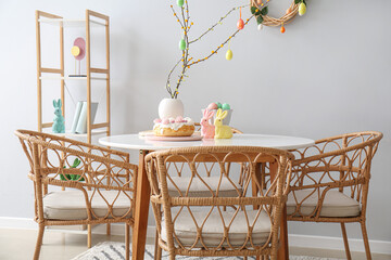 Interior of dining room decorated for Easter celebration with table and shelving unit