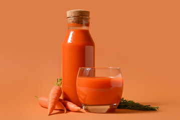 Fototapeta Glass and bottle of fresh carrot juice on orange background obraz