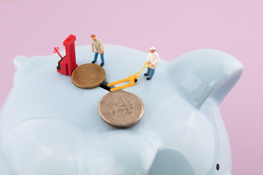 The microfilmer pushes coins into the deposit box