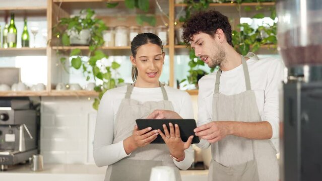 Coffee shop, tablet and barista people teamwork, services and online sales support, help or explain. Small business waiter or cashier person talk to new employee of digital app at restaurant or cafe