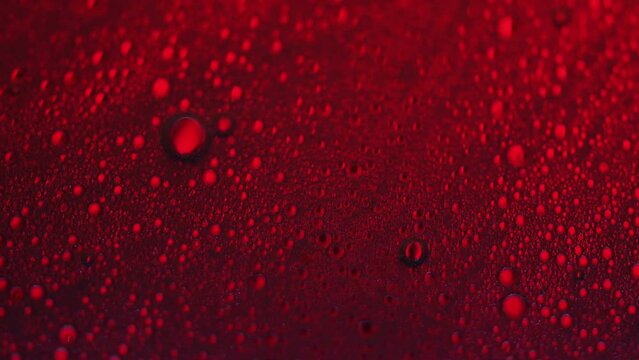 Abstract made by mixing oil, water and soap back lite with colored strobe light.