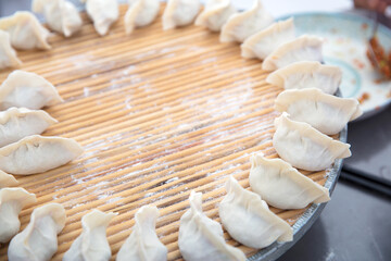 Fototapeta na wymiar Wrapped uncooked white flour dumplings