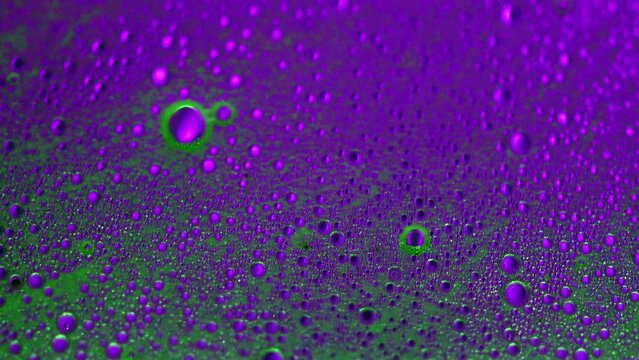 Abstract made by mixing oil, water and soap back lite with colored strobe light.