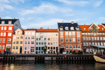 Fototapeta na wymiar Colorful houses along the canal in Nyhavn harbor in the historical city center of Copenhagen, Denmark