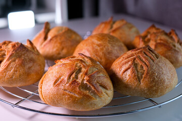 seven buns stand on stand just out of the oven light flashes slowly showing an outline beautiful pattern on each of them bakery products fresh pastries yeast-free dough restaurant serving vitamin B