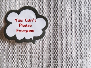 Word balloon stick on copy space background with handwritten text You Can’t Please Everyone -...