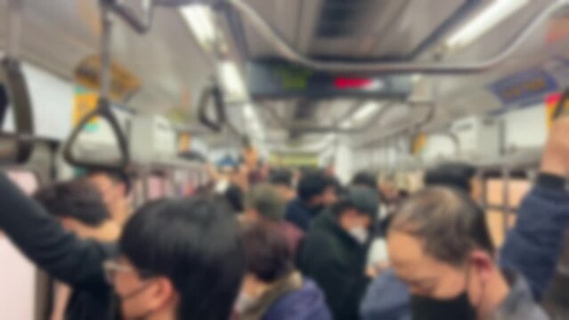 Seoul, South Korea, people are crowded in the subway running on their way home from work