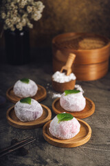 Japanese mochi or rice cake filled with red bean and strawberry, mint leaves on top. Japan traditional rice cake.