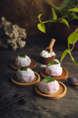 Japanese mochi or rice cake filled with red bean and strawberry, mint leaves on top. Japan traditional rice cake.