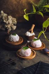 Japanese mochi or rice cake filled with red bean and strawberry, mint leaves on top. Japan traditional rice cake.
