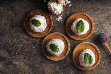 Japanese mochi or rice cake filled with red bean and strawberry, mint leaves on top. Japan...